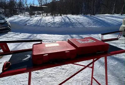 a red object sitting on a table in the snow at Beitos hjemmekoselige in Beitostøl