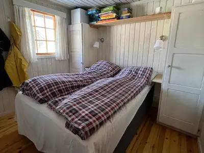 a bed in a room with two pillows on it at Beitos hjemmekoselige in Beitostøl