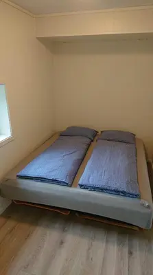 a bedroom with two beds in a room at Hillegård in Lærdalsøyri