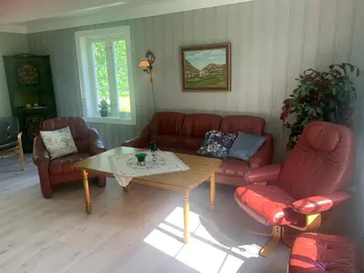 a living room with couches and a coffee table at Engen Gård in Innfjorden