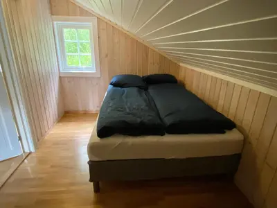 a room with a bed in a small room at Stryn - Faleide -hytte med fjord og fjell utsikt in Stryn