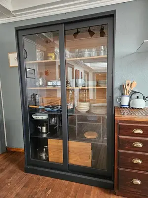 a cabinet with glass doors in a kitchen at Sigurd's Loft in Vossevangen