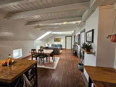 a living room with a table and a couch at Sigurd's Loft in Vossevangen