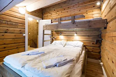 a bedroom with a bed in a wooden wall at Lake View Apartment 4 bedrooms and 2 bathrooms in Sykkylven