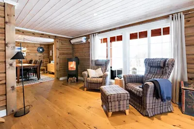a living room with two chairs and a table at Lake View Apartment 4 bedrooms and 2 bathrooms in Sykkylven
