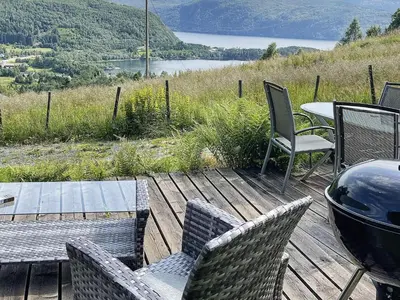 a deck with chairs and a table and a grill at 4 person holiday home in Bryggja-By Traum in Bryggja