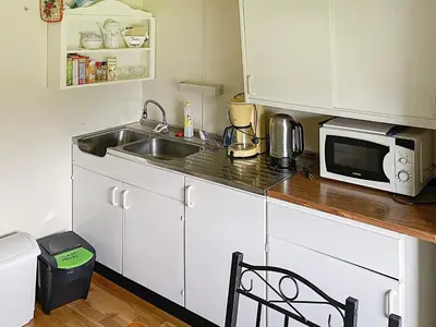 a kitchen with a sink and a microwave at 4 person holiday home in Bryggja-By Traum in Bryggja