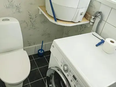 a bathroom with a washing machine and a toilet at 4 person holiday home in Bryggja-By Traum in Bryggja