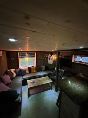 a living room with a couch and a table in a boat at Eidsviklaaven in Ålesund