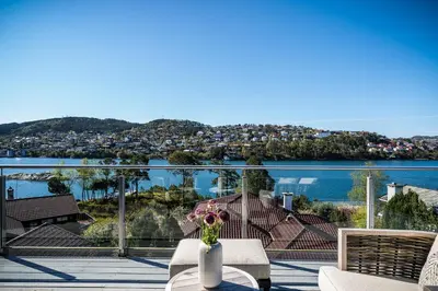 a balcony with a table and a view of the water at 