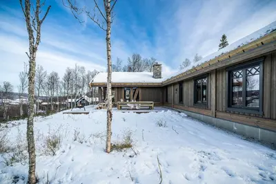 a house with snow on the ground in front of it at NEW LUXUARY Cabin with perfect location on Geilo. in Flatåker