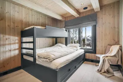 a bedroom with a bunk bed and a window at NEW LUXUARY Cabin with perfect location on Geilo. in Flatåker