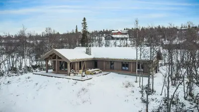 a house in the snow with snow on the roof at NEW LUXUARY Cabin with perfect location on Geilo. in Flatåker