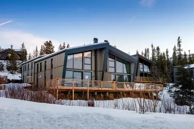 a house in the snow with a lot of windows at Gaustablikk Hytte - MountainView in Gaustablikk
