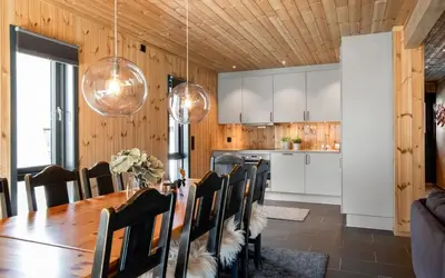 a kitchen and dining room with a table and chairs at Gaustablikk Hytte - MountainView in Gaustablikk