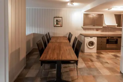 a dining room table and chairs in a kitchen at Bakkebyvegen 1D in Trysil