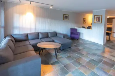 a living room with a couch and a table at Bakkebyvegen 1D in Trysil