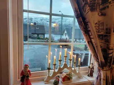 a window with a group of candles on a counter at Ålesund Apartment with free parking in Ålesund