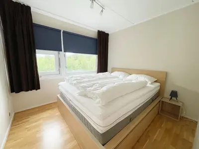 a bedroom with a bed with white sheets and a window at Actif 329 - apartment by Ål skisenter in Ål