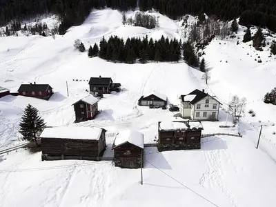 a snow covered mountain with houses and trees at Svarteberg Drengestugu - cabin by Ål skisenter in Ål