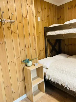a bedroom with a bunk bed and a small table at ! Perfect Snow Condition! Beautiful Apartment at Skagahøgdi with Panoramic View in Gol