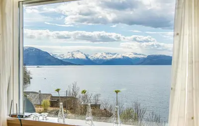 a window with a view of a lake and mountains at 5 Bedroom Amazing Home In Strandebarm in Strandebarm