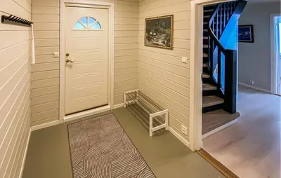 a hallway with a door and stairs in a house at 5 Bedroom Amazing Home In Strandebarm in Strandebarm