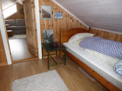a bedroom with a bed and a table in a room at Ny hytte i flott turterreng in Nore