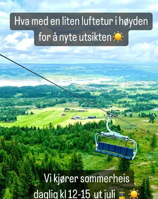 a gondola ride in the sky over a valley at Koselig leilighet med ski in ski out på Golsfjellet in Gol