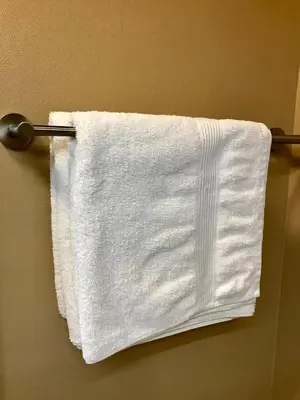 a white towel is hanging on a towel rack at Sanns villa in Lillehammer