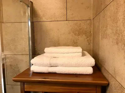 a pile of towels sitting on a table in a bathroom at Sanns villa in Lillehammer