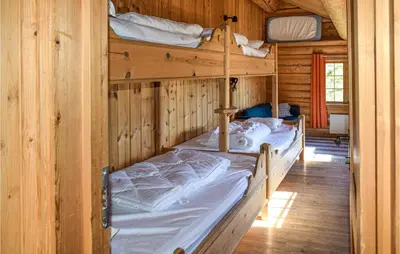 a bedroom with two bunk beds in a cabin at Låven in Rauland