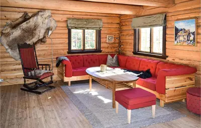 a living room with a red couch and a table at Låven in Rauland