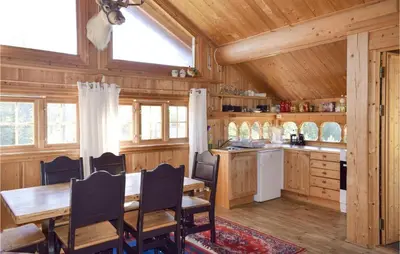 a dining room and kitchen with a table and chairs at Stallen 2 in Rauland