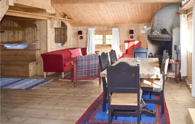 a living room with a table and chairs and a couch at Stallen 2 in Rauland