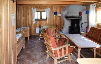 a living room with a table and a fireplace at Stallen 1 in Rauland
