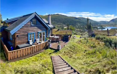 a small house on a hill with a deck at Nice Home In Rjukan With Wifi in Rjukan
