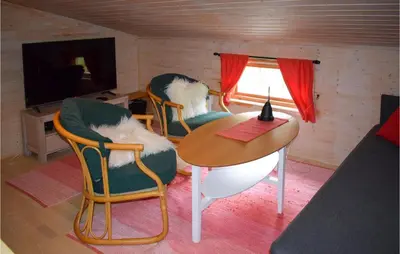 a room with two chairs and a table and a television at Nice Home In Rjukan With Wifi in Rjukan