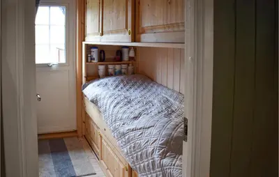 a small bed in a cabinet in a room at Nice Home In Rjukan With Wifi in Rjukan