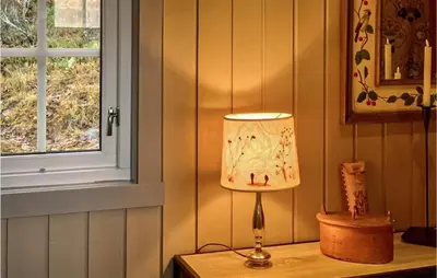 a lamp sitting on a table next to a window at Beautiful Home In Uvdal With Kitchen in Uvdal
