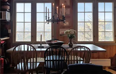 a kitchen with a table with four chairs and windows at Beautiful Home In Uvdal With Kitchen in Uvdal