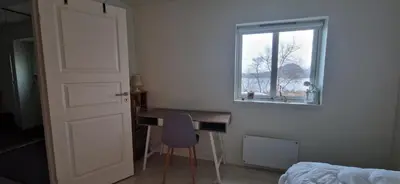 a bedroom with a desk and a window at Relaxing place on Godøya in Godøy