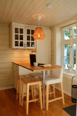 a kitchen with a wooden table with a laptop on it at Charming Bergen house, rare historic house from 1779, Whole house in Bergen