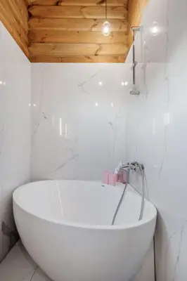 a bathroom with a white tub and a toilet at Trysilsetra 35 in Trysil