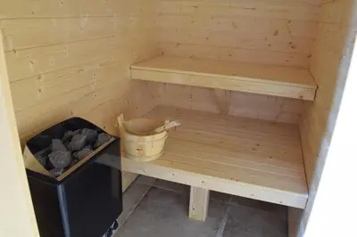 a wooden sauna with a trash can next to it at Trysilsetra 35 in Trysil