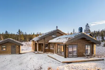 a log cabin in the winter with snow on the ground at Trysilsetra 35 in Trysil
