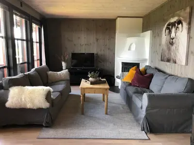 a living room with two couches and a television at Beitotind sentralt på Beitostølen in Beitostøl