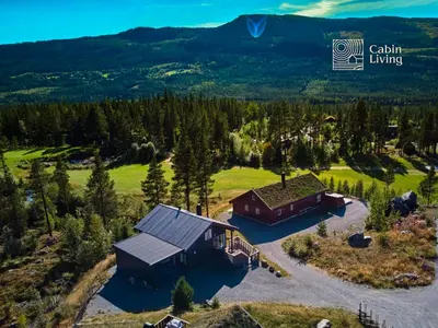 an aerial view of a house with a mountain in the background at Family friendly cabin Hemsedal GolfAlpin golf, ski-out, fireplace & wifi in Hemsedal