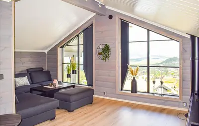 a living room with a couch and a large window at Stunning Home In Rauland With Sauna in Rauland