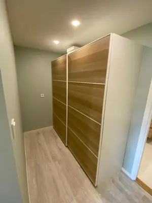 a closet with a wooden door in a room at Fjord studio in Sunde